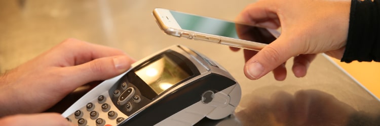 Small business owner looking to change merchant solutions with Total Merchant Services featuring a checkout transaction