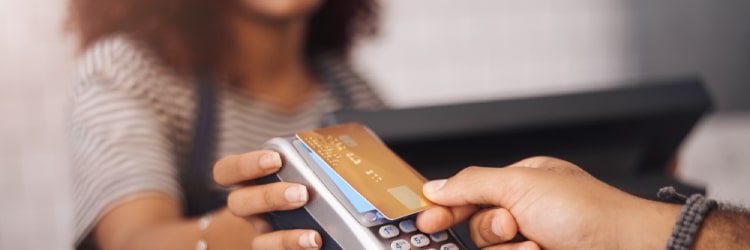 A new client curious about switching merchant services with Total Merchant Services featuring young lady holding up credit card processing device