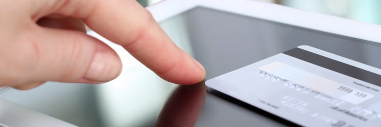 Business owner switching payment processors to Total Merchant Services, featuring young business man filling out free quote form